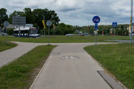 Tieši pirms nākamā rotācijas apļa veloceļš atkal "pārtrūkst". Velomaršruta zīme vēsta, ka jādodas pa labi.