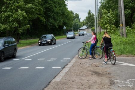 Tālāk veloceļš šķērso brauktuvi, kur maksimālais atļautais braukšanas ātrums ir 70 km/h. (Fotogrāfijas uzņemšanas brīdī. Raksta publicēšanas brīdī maksimālais atļautais braukšanas ātrums jau ir ticis samazināts līdz 50 km/h). Satiksme šeit ir ļoti intensīva un brauktuves šķērsošana mēdz būt bīstama.